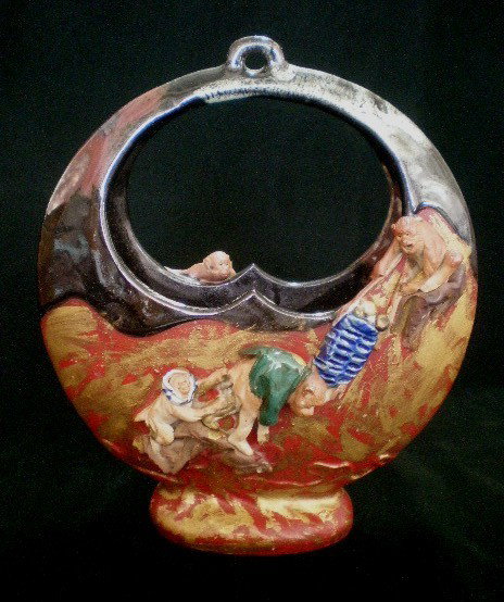 Sumida ware vase: Sumida ware vase- ornamented with 3 playful monkeys. 8 5/8''h