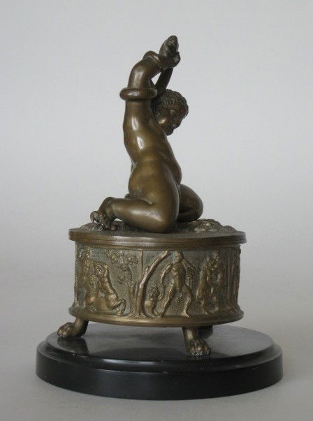19th c. bronze figural ink well: 19th c. bronze figural ink well- Infant Hercules Wrestling a Snake- set in marble base, base ornamented with mythological frieze with 3 paw feet, figure detached from top. 6 1/2''h.