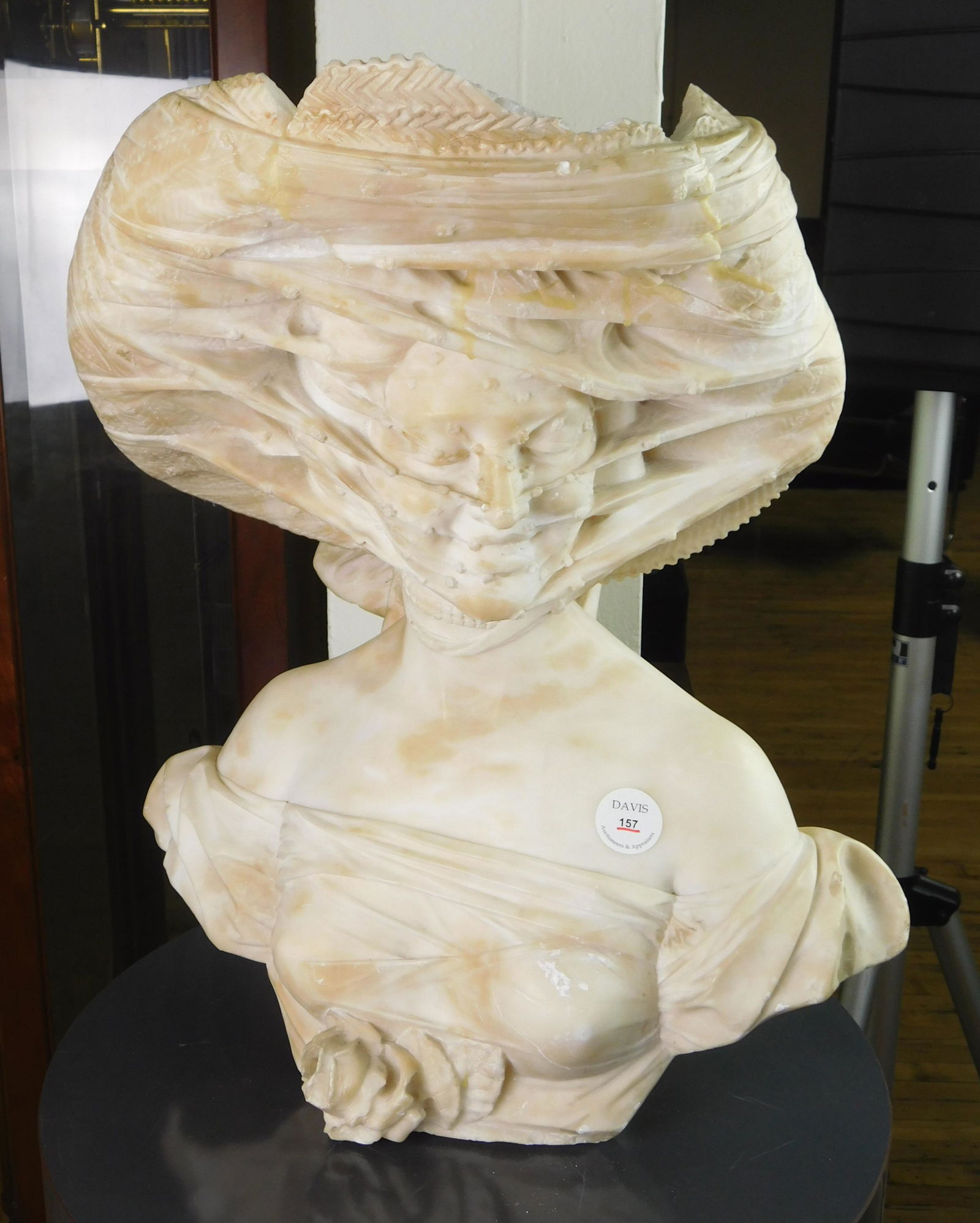 Marble statue of Lady in Veil: Marble statue of a Young Lady wearing a Hat and Veil, several repairs and loss to top front of hat. 23 1/2 x 19 x 10''