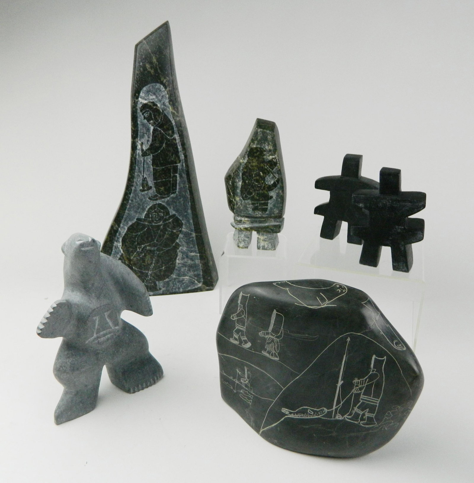 5 Inuit stone carvings: 5 Inuit stone carvings 1 & 2). Robert Hallauk / Arviat- Standing Polar Bear with Face; Two Inukshuks- 2009, signed; 3). Kaunaluk / Inujvik- etched stone relief; 4 & 5). Annie Ainalik Parr / Cape Dorse