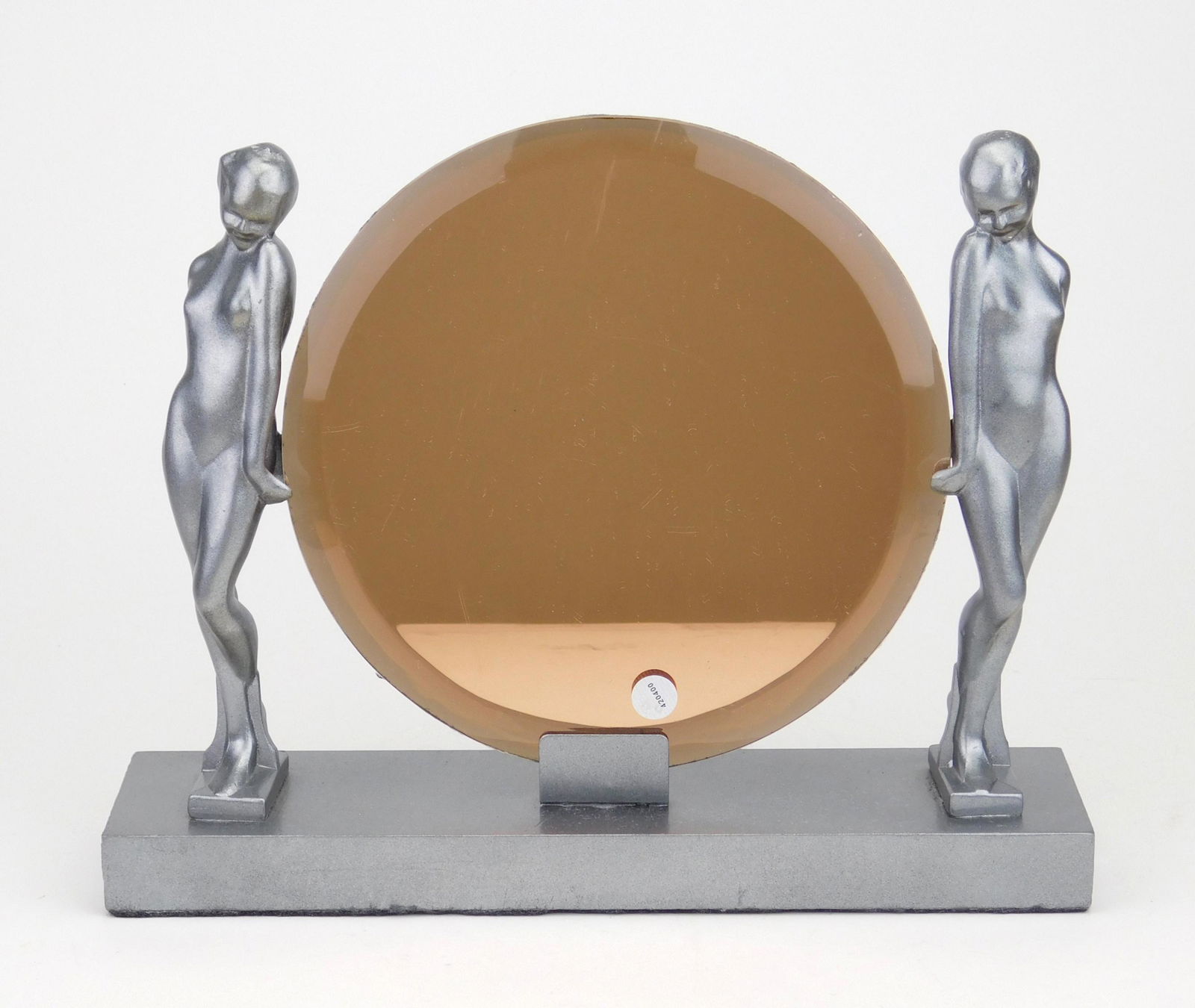 Frankart vanity mirror: Frankart vanity mirror in the form of a two nude holding a beveled peach color mirror, gun metal base, some wear as to be expected with age and use. 10 x 11''