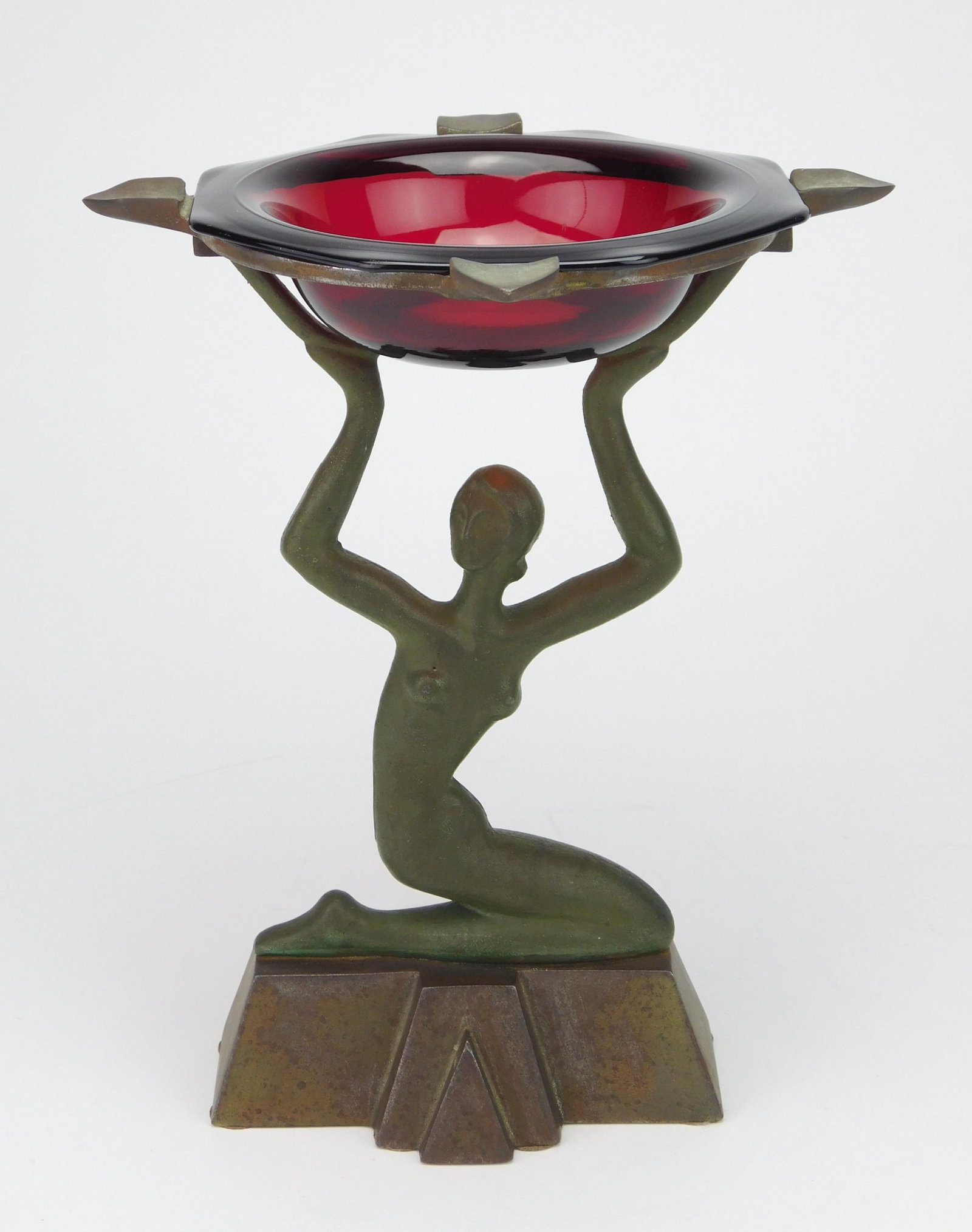 Seville Studios ashtray holder: Seville Studios, Seville, OH ashtray holder, cast nude with original red ruby glass insert with cigarette rests, cast bronze finish. 10''h