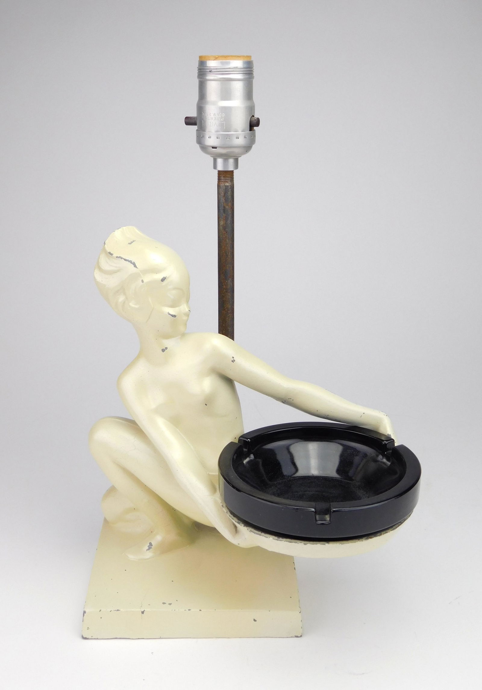 Frankart Lamp/ Ashtray: Frankart ashtray lamp combination, #T383, ca. 1920's, a pert nude replete with rhythmic lines, 'Martian' girl combo lamp base and holding ashtray off to side, original finish. 9 1/2''h
