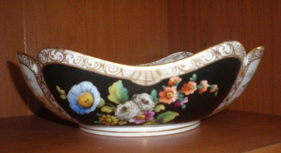 Meissen porcelain bowl: Meissen porcelain bowl- exterior painted with two vignettes of outdoor scenes and 2 vignettes of floral spray on black, marked on bottom, very good condition. 8 1/4''l, 8 1/4''w, 3''h