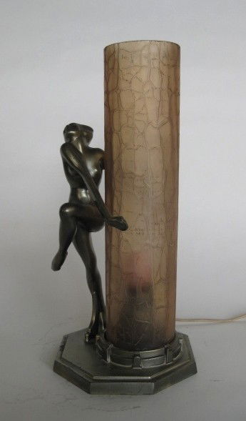 Frankart lamp: Frankart lamp, L229- A nude holds a round cylinder of frosted crackled glass with shields, the light within it, gun metal finish, marked, nicks and some loss to finish. 12 3/4''h
