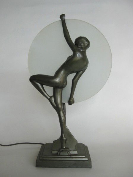 Frankart Silhouette lamp: Frankart Silhouette lamp, L245- Dancing nude holds aloft a 10'' disc of heavy frosted plate glass which shields a light, green finish, marked, some nicks to finish. 16''h