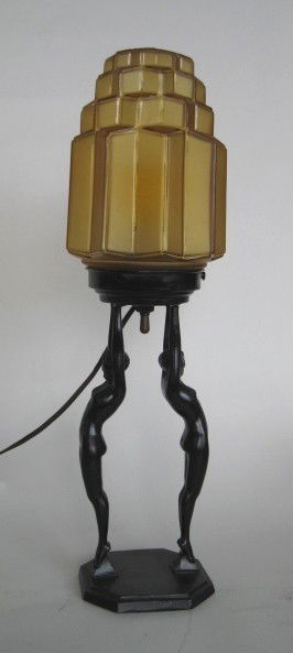 Frankart lamp: Frankart lamp, L211- Two nudes hold aloft 8'' moderne amber glass shade, marked, some nicks to finish. 20''h