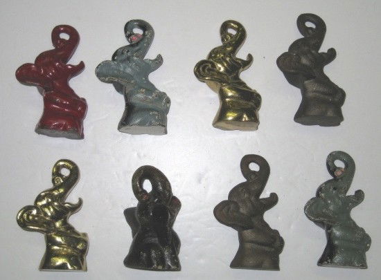 8 Figural elephant bottle openers: 8 Figural elephant bottle openers- black elephant with red tongue, stamped on bottom 'J W Wright Inc', wear throughout, various sizes.