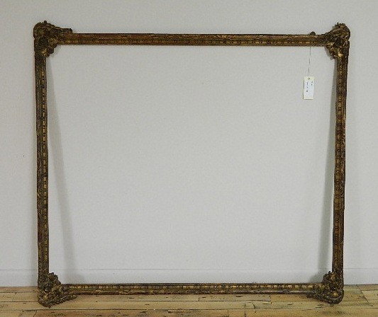 Hand carved gilded frame: Hand carved gilded frame with floral corner flourished and openwork braids, one openwork braid element missing, other very small losses. int 58 1/4 x 43 3/4'' ext 61 1/4 x 51 1/8 x 2''