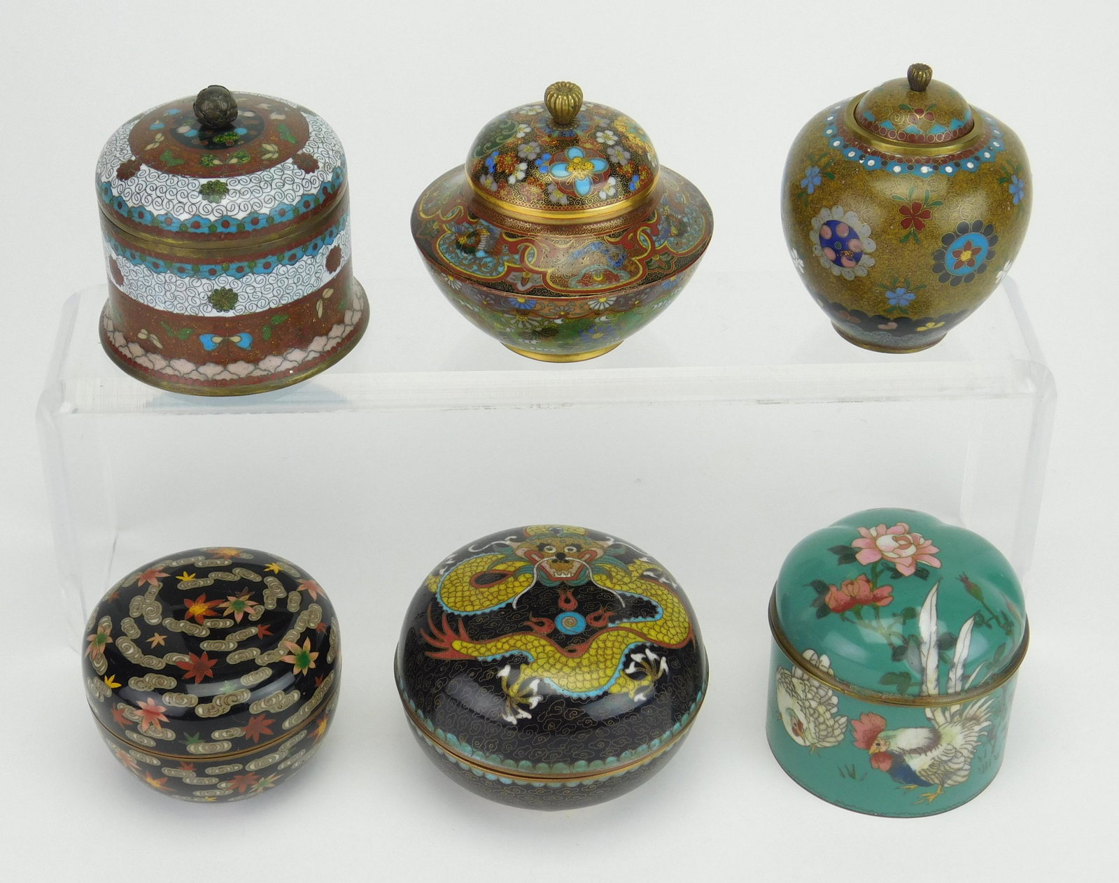 6 Cloisonne circular jars with lids: 6 Cloisonne circular jars with lids, various patterns and colors, various pitting and nicks. 2 1/4'' to 3 1/2''h