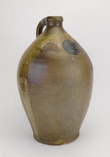 Stoneware jug with incised decoration: Stoneware Jug with incised decoration of a man's face in a circle. 16 x 9 1/2"