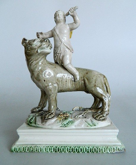 John Voyez Staffordshire figurine: John Voyez Staffordshire pottery figurine- Winged Cupid on a Lioness, ca. 1785, several areas of repair and restoration. 8 1/4''h