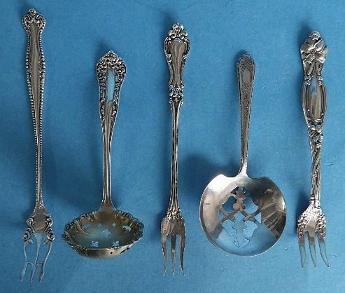 5 Sterling silver serving utensils: 5 Sterling silver serving utensils- 3 seafood forks: 1 R. Blackinton & Co., 1 Towle- Canterbury pattern, and 1 unknown; and 2 berry spoons, 3 oz