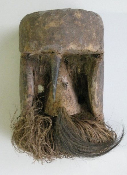 Dan Liberia and Cote d'Ivoire Kagle mask: Dan Liberia and Cote d'Ivoire Kagle mask- wood, duiker horn, raffia, hair and mirror. An aggressive masquerade, Kagle may hurl sticks at the audience, whipping them into a frenzy. Some insect damage,