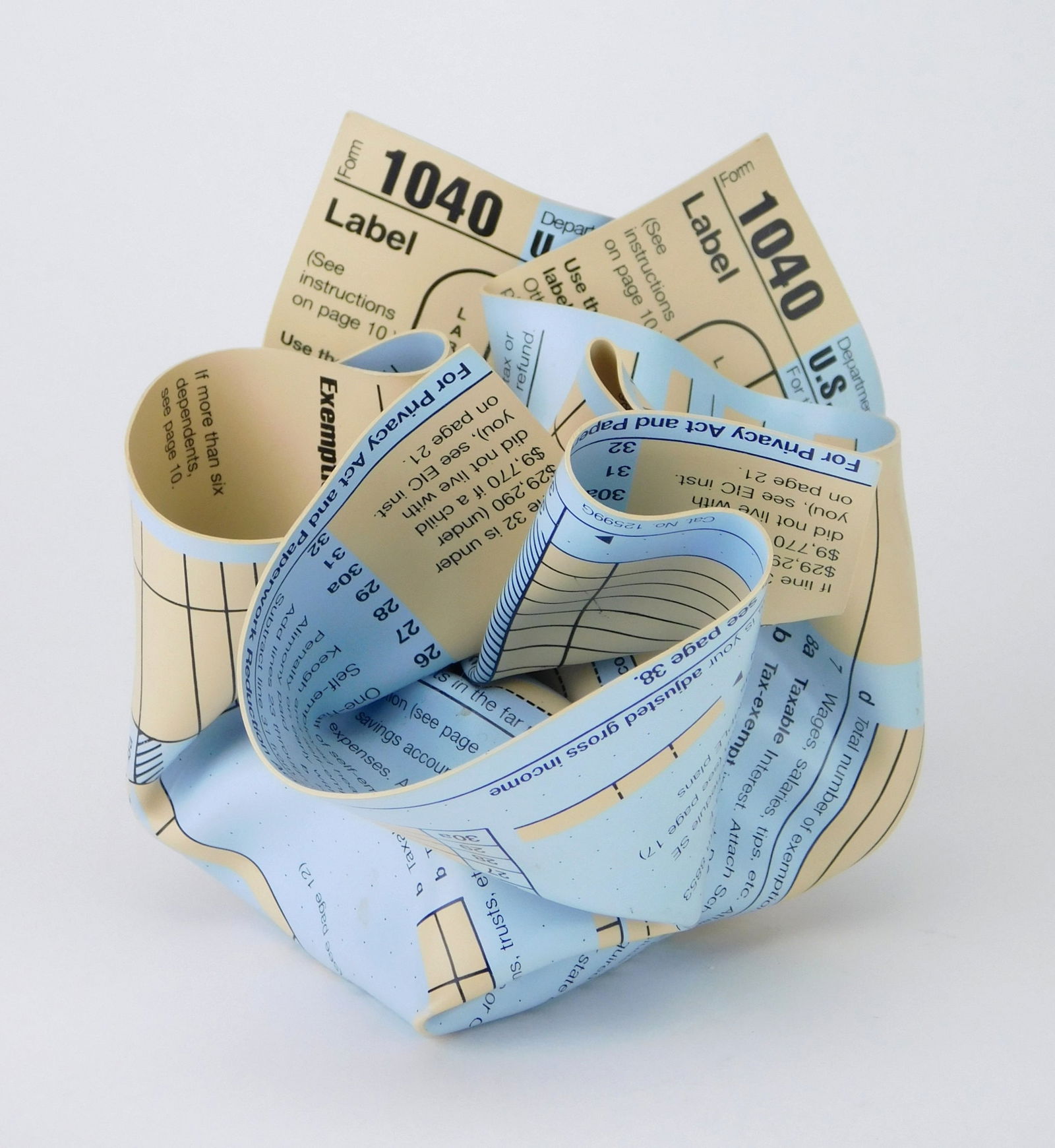 Tibor Kalman (Hungarian/ American 1949-1999) paperweight: 1040 Tax Form rigid vinyl wrapped around a steel weight, ca. 1980's, manufactured by M&C0. Labs, brand stamped on underside. 3 1/2 x 3 1/2" Provenance: Private collection- Roc