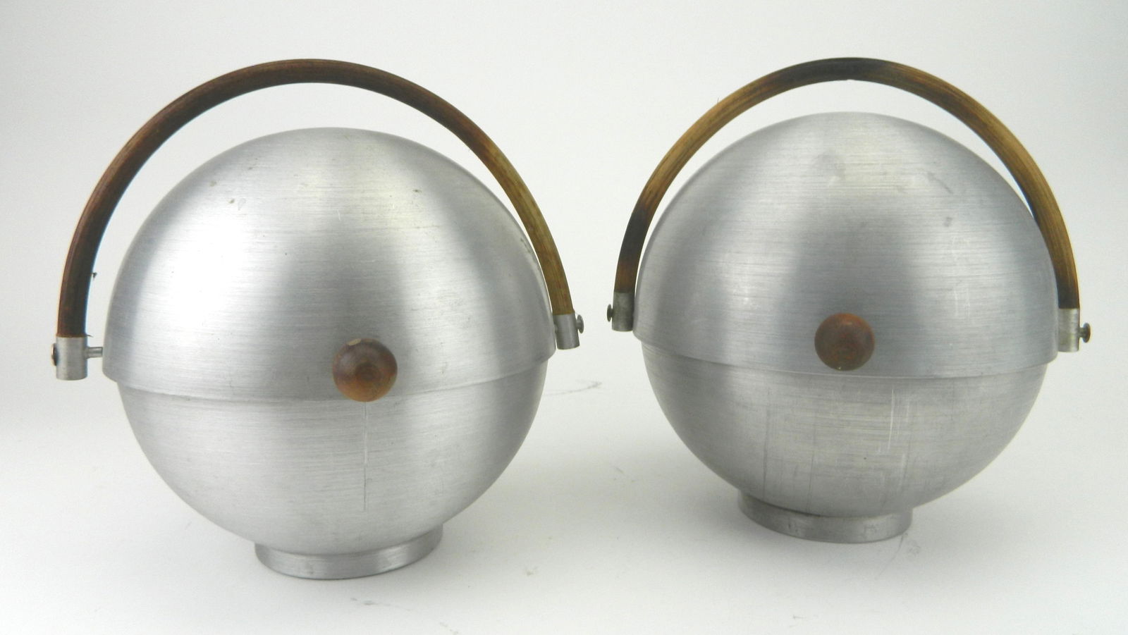 2 Russel Wright aluminum ice buckets: Both signed. 11"h 11" sphere Condition: Some wear as expected from age and use Provenance: Private collection- Elyria, OH