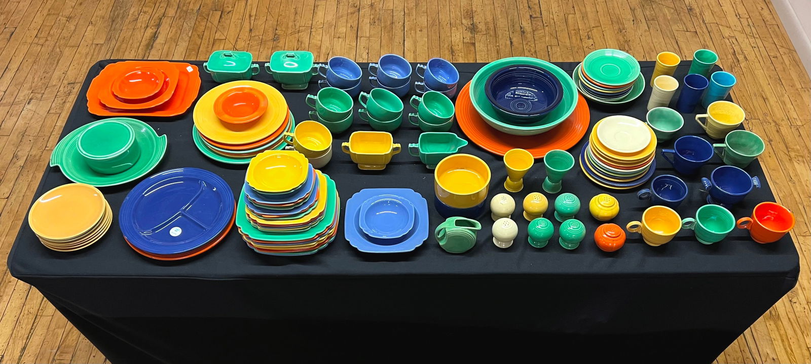 Large collection of Fiesta ware: including large and small circular platter and medium rectangular platter, 2 divided plates, 6 luncheon plates, 5 juice tumblers, 2 double egg cups, 8 teacups, 4 slat and pepper shakers, 1 sugar bowl,