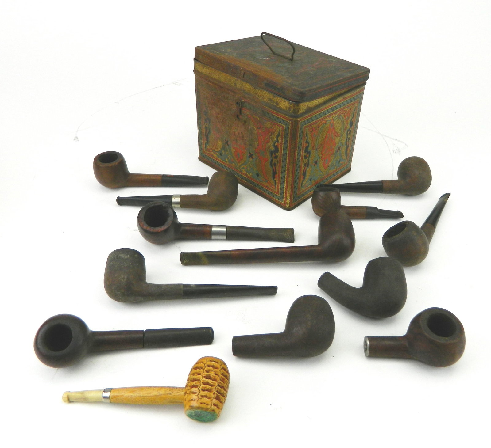 12 Wooden tobacco pipes: 11 unmarked and 1 marked Pock-It; along with corn cob tobacco pipe (sticker has rubbed off). Condition: Wear from use and residue in the chambers Provenance: Private collection- Clevel