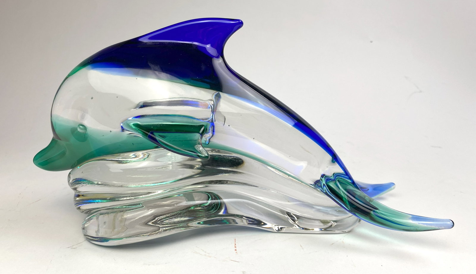 Archimede Seguso Murano glass sculpture: Dolphin glass sculpture in blue, green and clear glass, etched signature and Murano label on bottom. 6"h; 11 1/2"l Provenance: Private collection- Chautauqua- NY