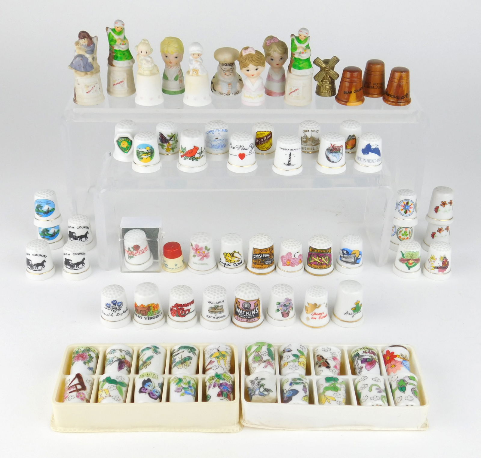 60 + souvenir thimbles: including states, advertisements, flowers and figural, mostly porcelain.