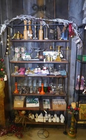 Display stand with 6 shelves filled with bric-a-brac