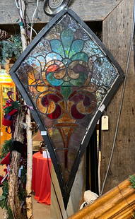 Leaded stain glass window: unusual kite form in burnt orange, red and turquoise. 53 x 31"