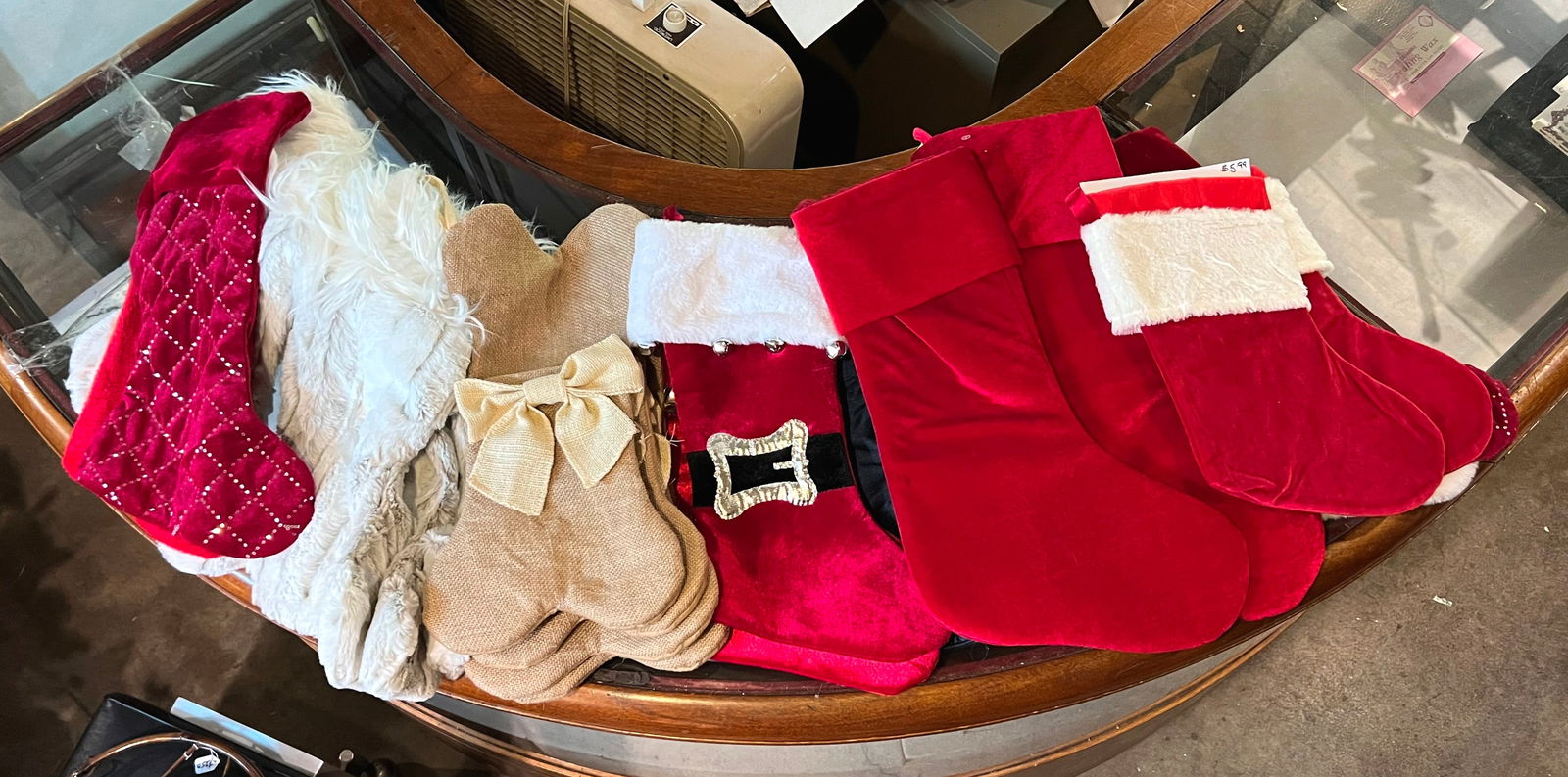 Lot of stockings: 20+ stockings, 5 Christmas tree skirts, table runners and Santa mask. Table runner is 84 x 36"