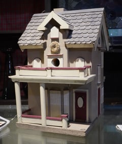 Carved and painted wood bird house