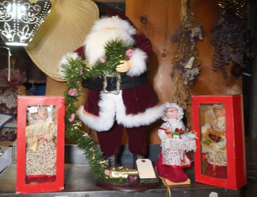 Santa Claus figurine and 3 Mrs. Claus