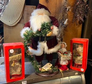 Santa Claus figurine and 3 Mrs. Claus