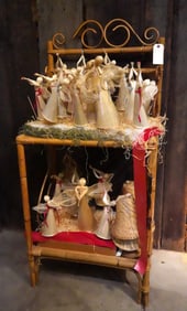 Lot of corn husk angels and bells with display stand.