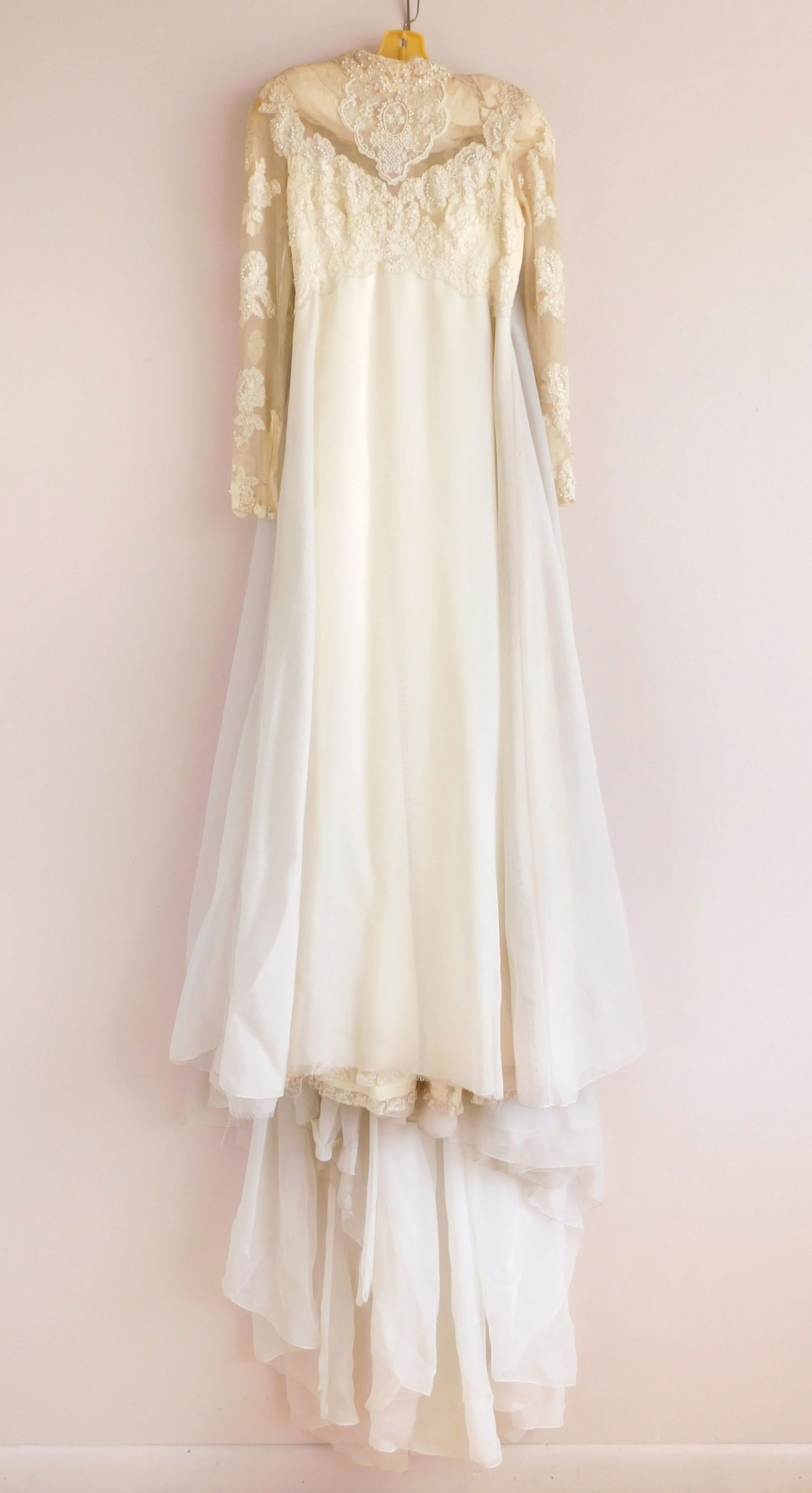 Vintage wedding dress: with lace tulle and beadwork on upper bodice and on long sleeves with a high neck, empire waist and tulle mesh overlay from waist down, zipper closure on back and wrists. Bust- 34"; Waist- 28&quo