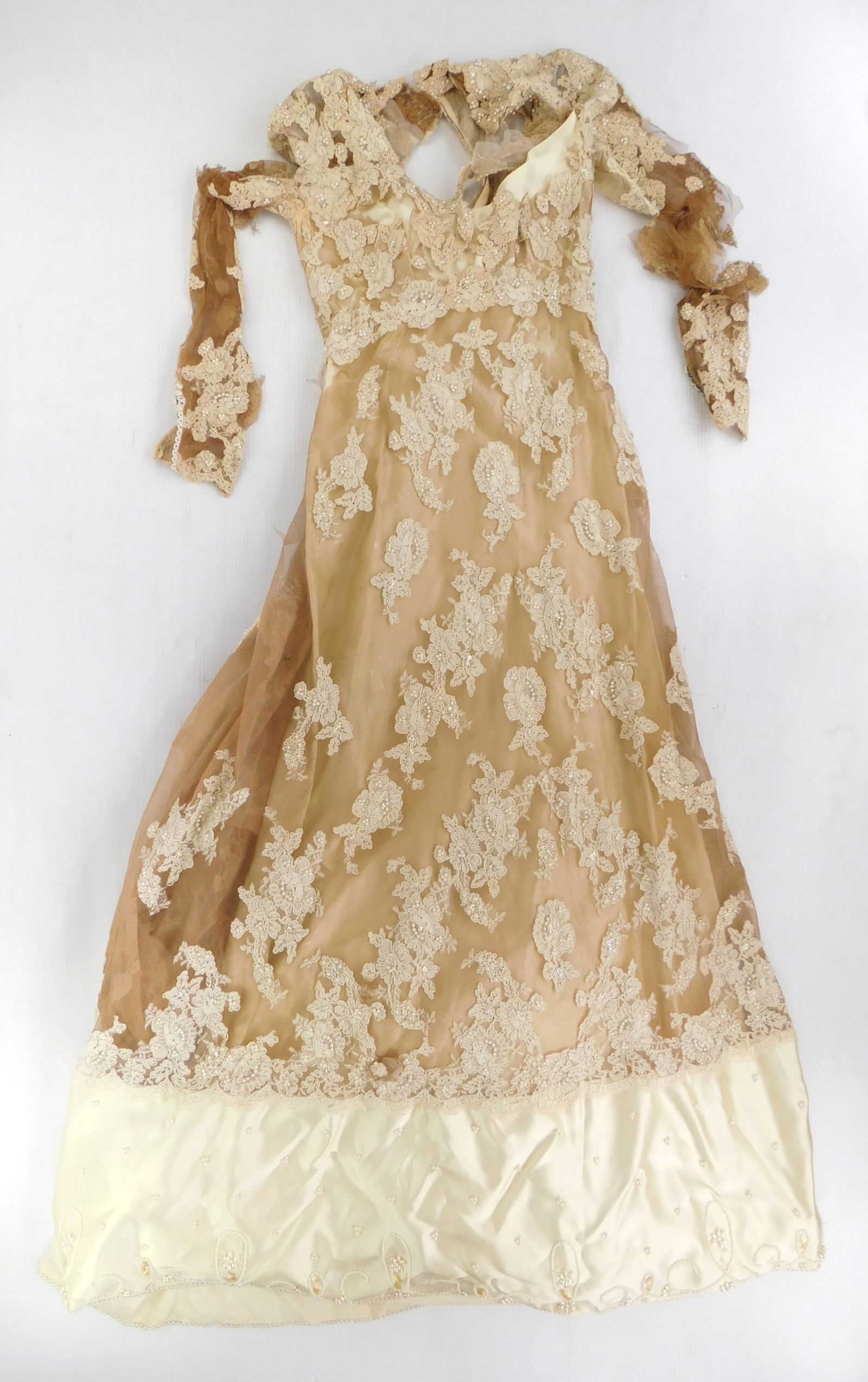 Vintage wedding dress: with lace and beadwork on nude color tulle mesh, with sating trim at bottom and long sleeves. Bust- 34"; Waist- 28" & Collar to bottom hem- 55"