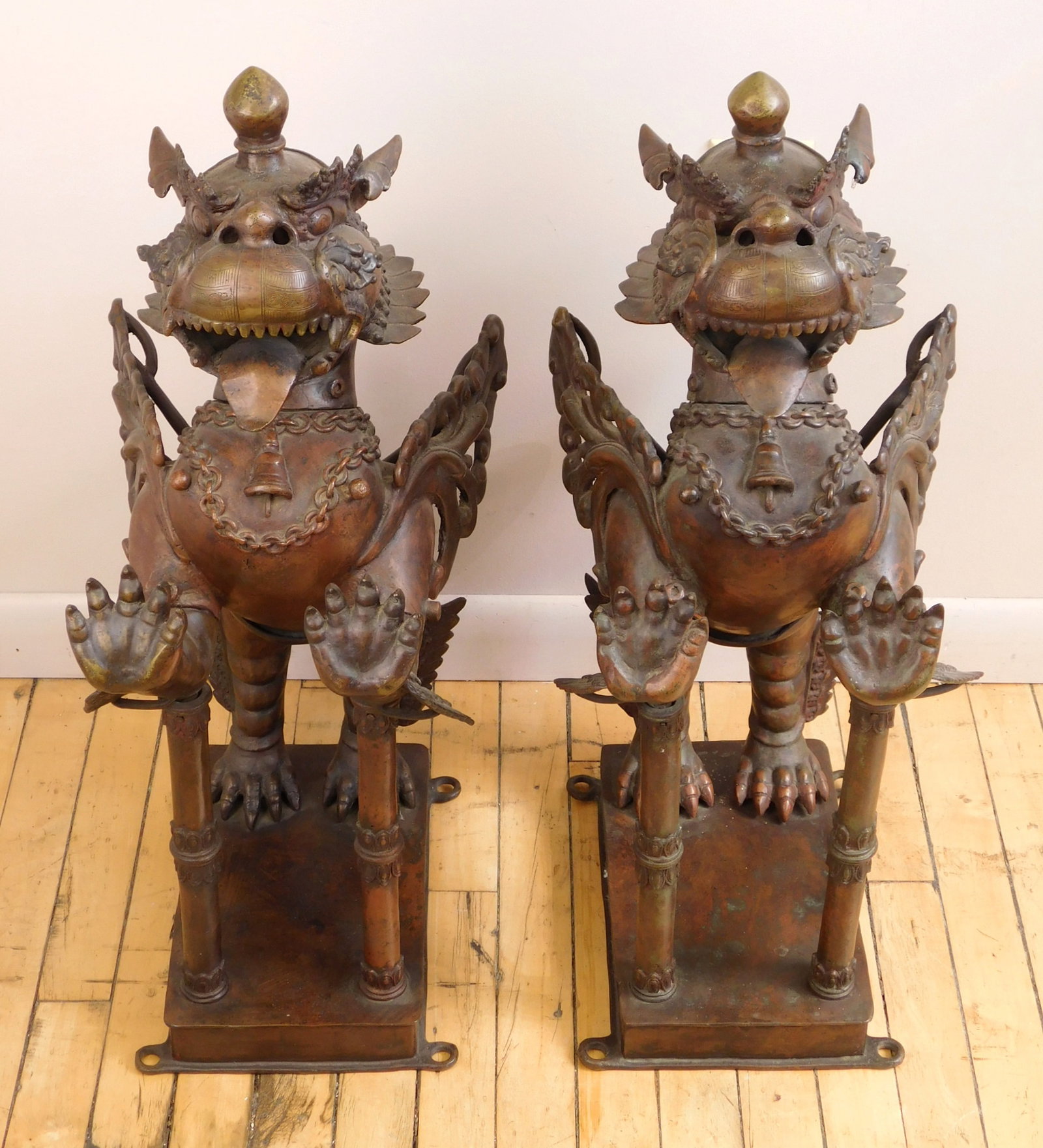 Pair of Tibetan bronze leogryphs: This mythological legendary temple palace guardian featured in standing pose with open mouth exposing its fangs. 29 x 18 1/2 x 12" ea. 65 lbs. ea. Provenance: Private collection- Bay