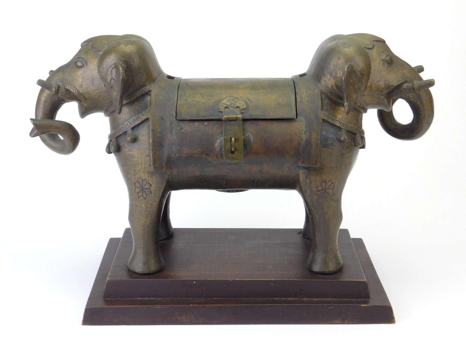 Asian bronze dual headed elephant incense burner: body has hinged top and screen incorporated on the underside to sift out ashes, set on wood base. 11 x 12 1/2 x 7" Provenance: Private collection- Bay Village, OH *** PLEASE READ: IMPORTANT NOTE 
