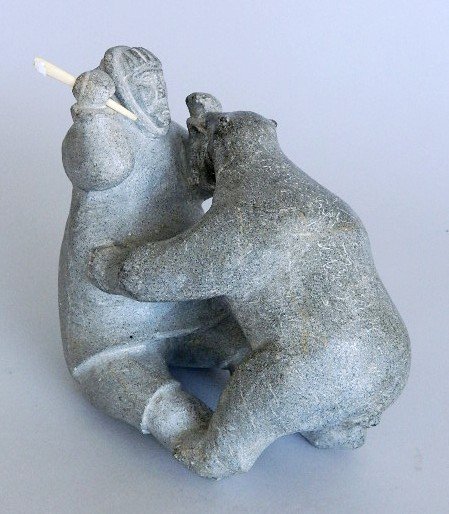 Inuit stone carving: Inuit stone carving- Eskimos fighting a bear. 6''h