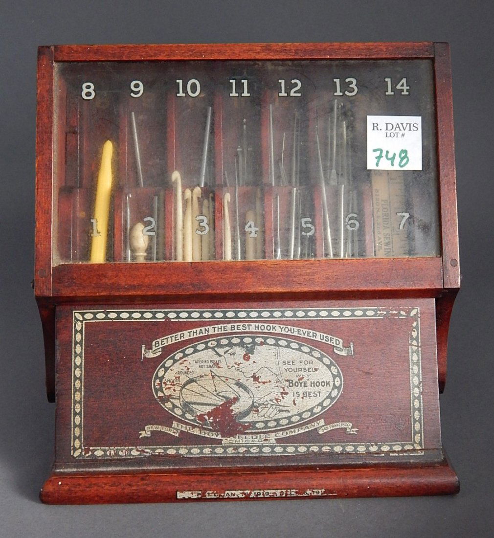 Boye Hook Needle Company display case: Boye Hook Needle Company display case, with an assortment of miscellaneous hooks, wear throughout. 7 1/2 x 5 1/4 x 7 1/2''