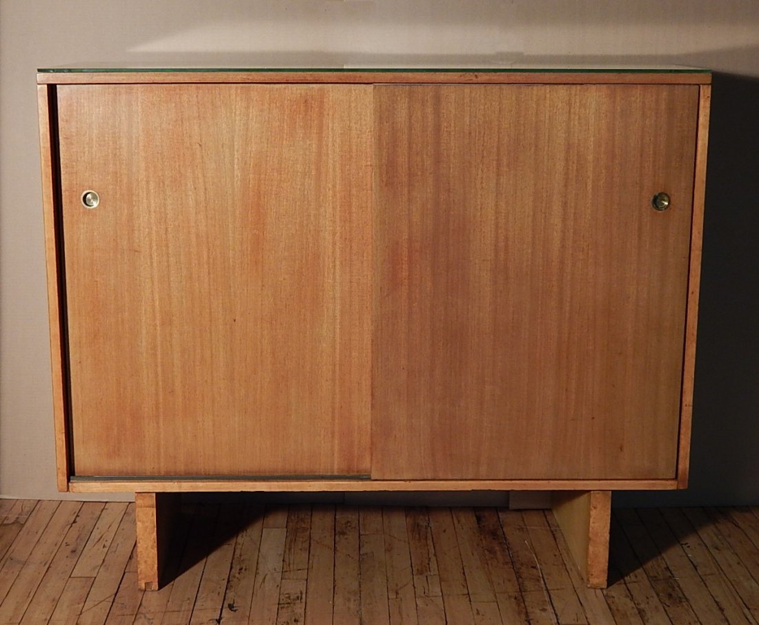 Widdicomb cabinet: Widdicomb cabinet with 2 sliding doors, glass top and several drawers / trays, logo on top drawers, wear from use and chipping to corners of glass top. 43 x 51 1/2 x 18 1/2''
