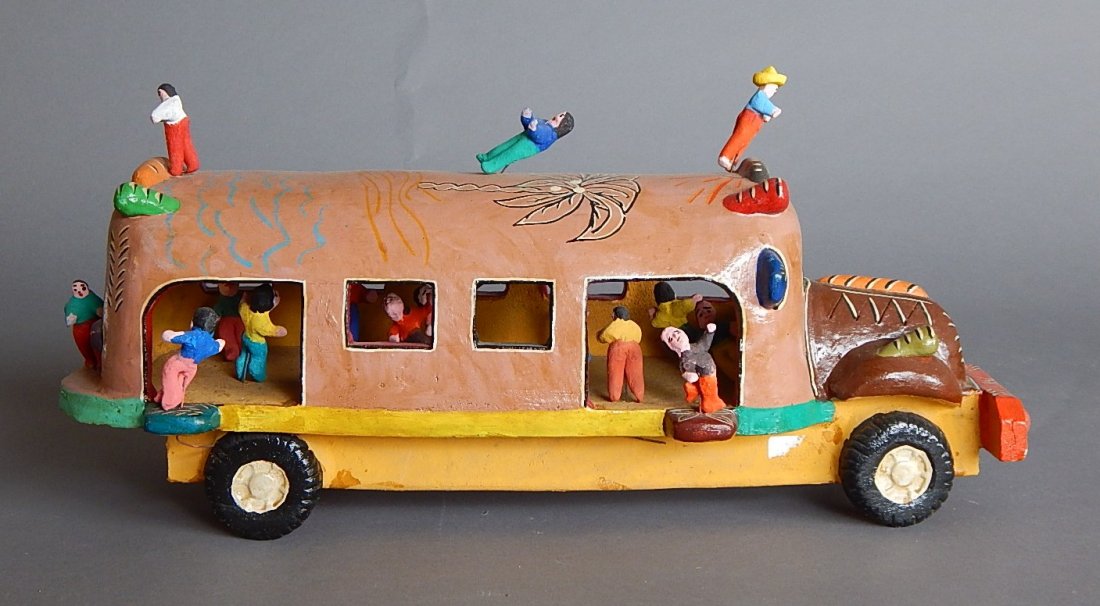 Ocuchimo clay sculpture: 20th c. Mexican Ocuchimo clay sculpture- bus with Figures. 7 1/2''h, 18''l