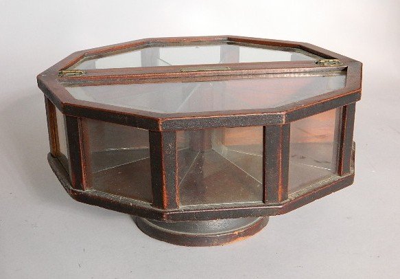 Candy store revolving display case: Candy store display case, ''The Revolving Counter Cabinet-Patd 1919'', mfgd by A.W. Funke-San Fran, CA'', 10-sided glass display w/divided lift lid on turned walnut base, metal slots under glass to in