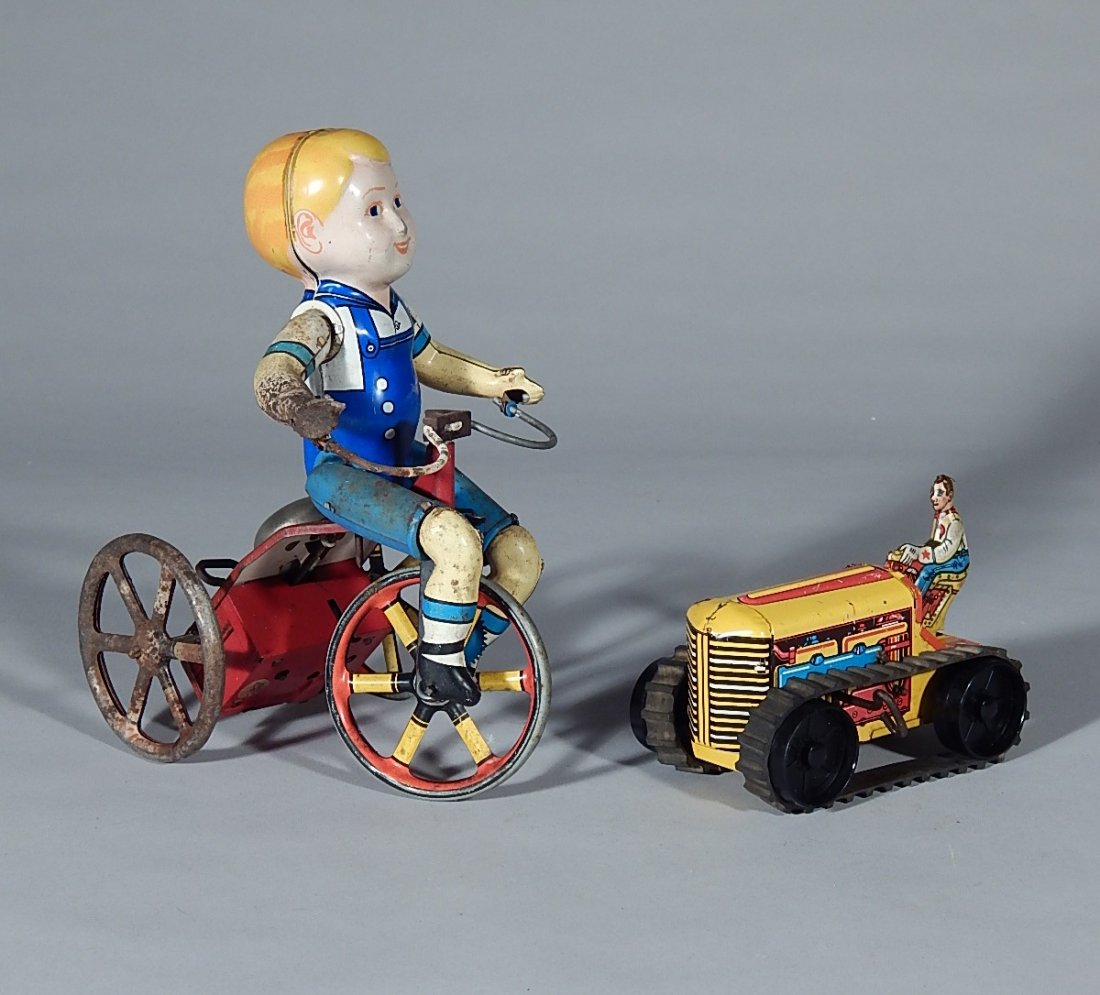 2 Vintage tin litho wind-up toys: 2 Vintage tin litho wind-up toys- Louis Marx & Co., farm tractor with driver, marked on bottom; and Boy on Tricycle; wear throughout.