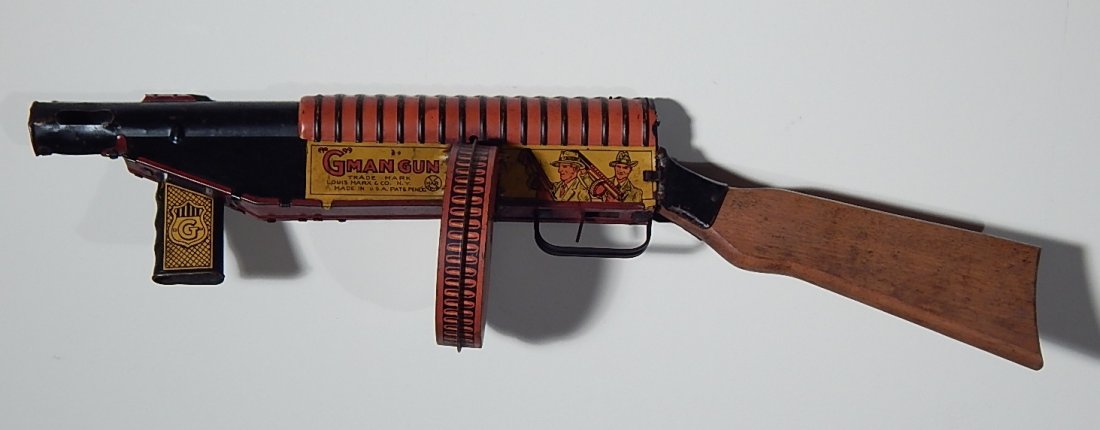 Louis Marx & Co. wind-up toy: Louis Marx & Co. ''G-Man'' wind-up tin litho toy gun, wear throughout. 22''