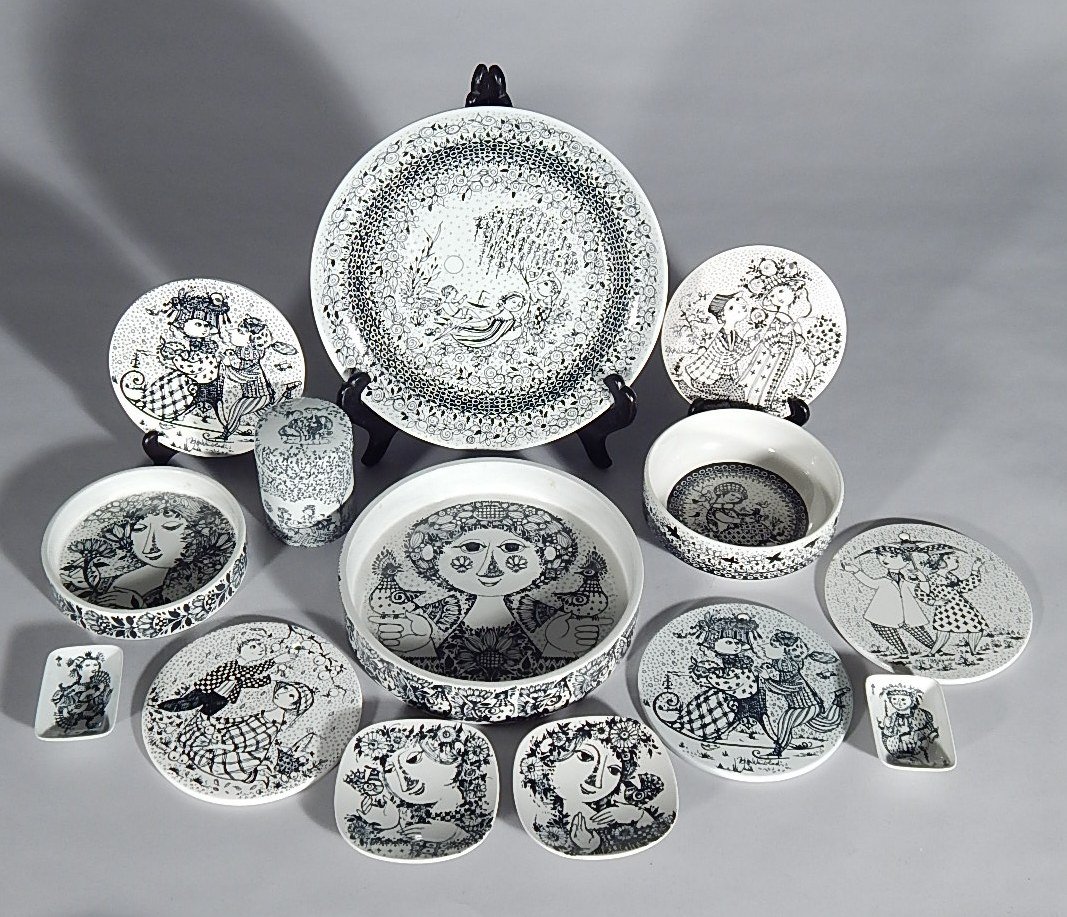14 Bjorn Wiinblad pottery pieces: 14 Bjorn Wiinblad pottery pieces for Nymolle- plate; 2 dishes; bowl; container with lid; 5 calendar plaques, January (2), April, June, October; 2 small dishes; and 2 small rectangular dishes- all in b