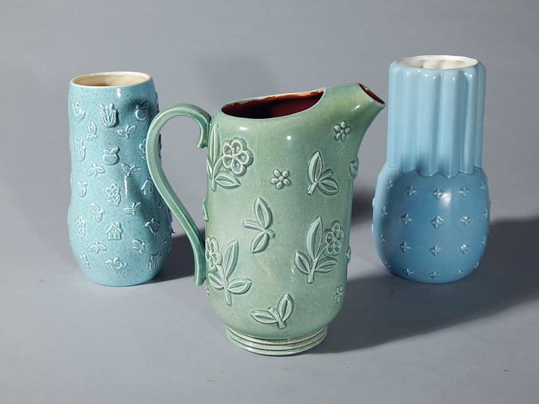 2 Red Wing Pottery vases: 2 Red Wing Pottery vases- no. 1197 in blue glaze, with embossed fleur di lis; and M-1443 in turquoise glaze with embossed houses, birds, fruit and flowers, designed by Charles Murphy- both marked on b
