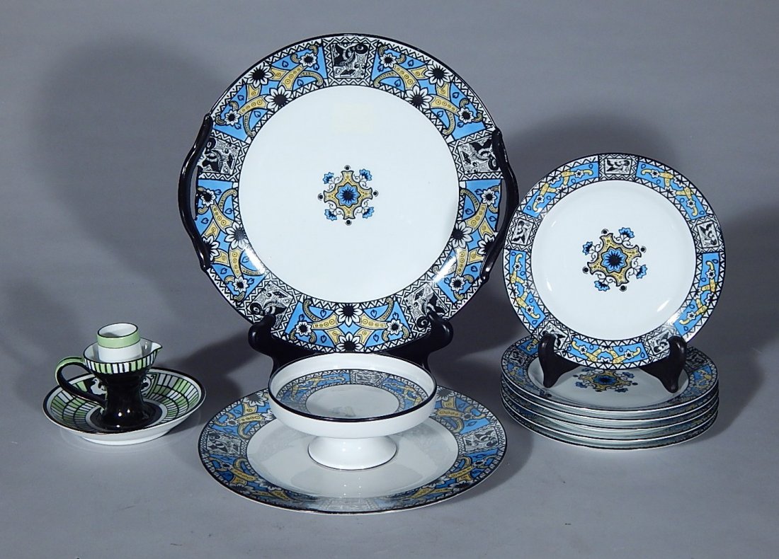 Noritake Porcelain 8 plates and candlestick: Noritake Porcelain 2 serving plates and 6 small plates, decorated in blue, yellow and black; and candlestick in black and green glaze, stamped on bottom, good condition. plates 10 1/2'' dia.; 8 3/8'' 