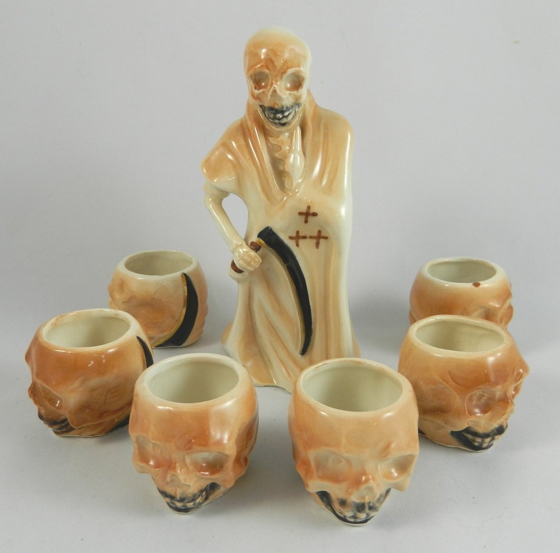 Japanese decanter and shot glass set: Liquor- Japanese porcelain decanter in the form of the grim reaper together with 6 skull form shot glasses. 6''h