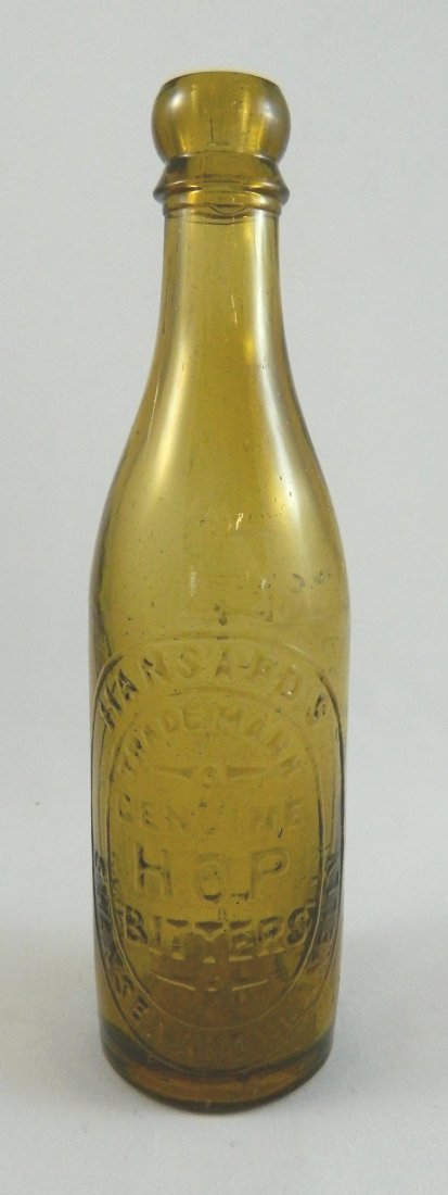 Bitters - round bottle, Hansard's: Bitters- round, yellow amber, marked 'Hansard's / Trade Mark / Genuine / Hop / Bitters / Swansen And Llanelly - Hansard's', collared mouth with ring, smooth base, embossed 'H/1895', 9''