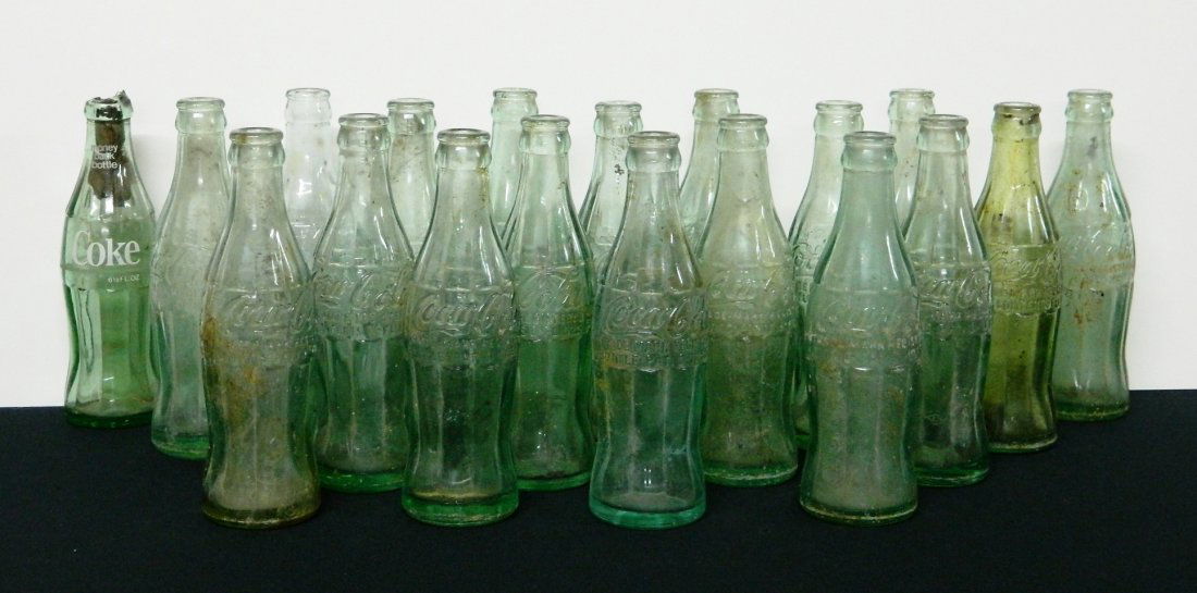 18 Coca Cola bottles: Soda- 18 Coca Cola bottles- including 15 Warren Ohio, 1 Cincinnati and Cleveland Ohio, 1 Painesville Ohio and 1 Miami Florida.