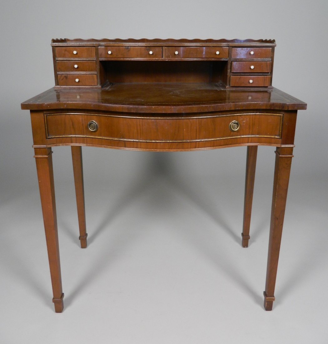 Hepplewhite Style Ladie's Writing Desk: Hepplewhite Style Ladie's Writing Desk in Mahogany, serpentine front, stepped top, with leather in-set, square tapered legs. 36 x 31 1/2''