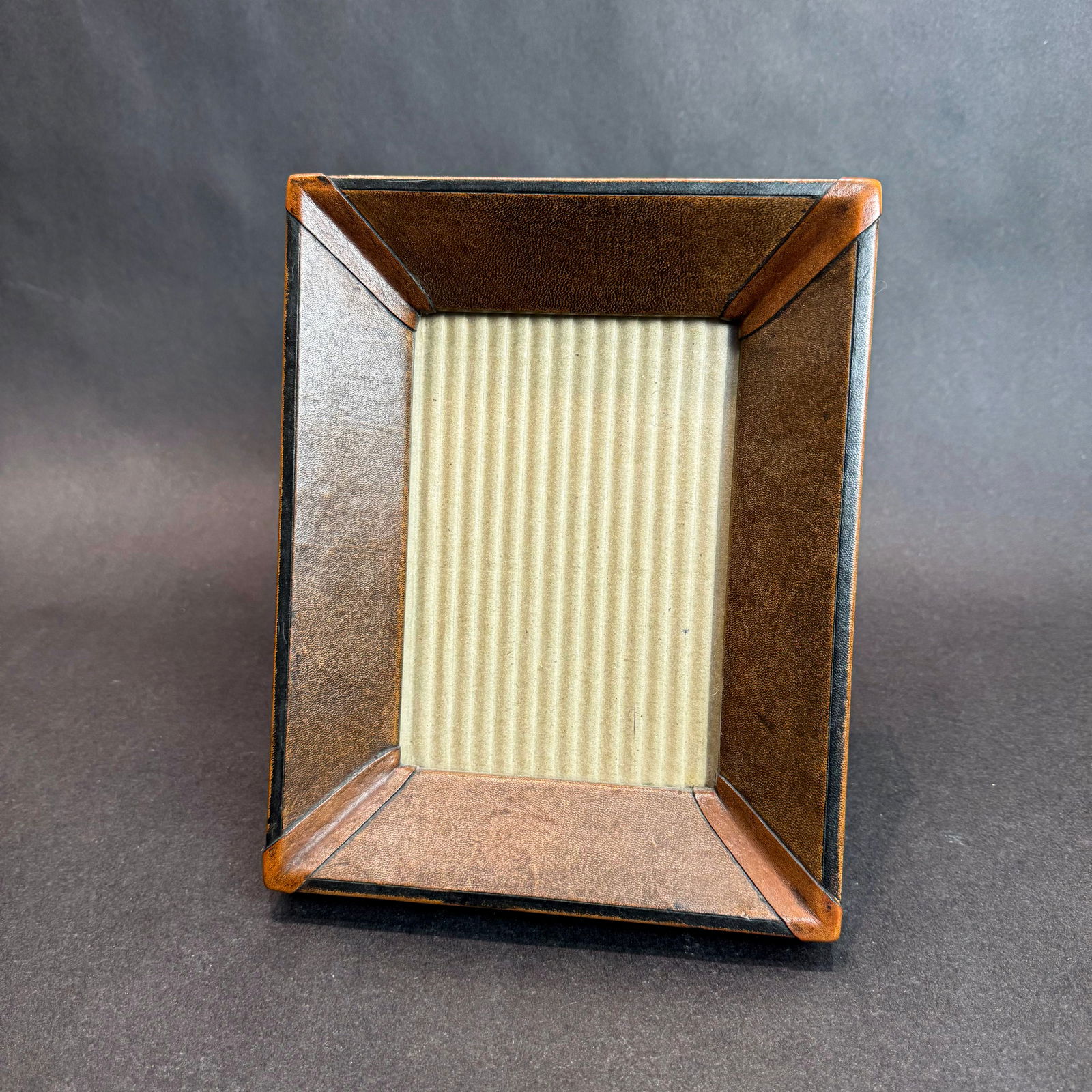 5x7 Mercier Leather-wrapped Tabletop Frame: 5x7 Mercier Leather-wrapped Tabletop Frames Frame holds one 5x7 photo and includes a easel-back to sit on a table or shelf. Crafted in Peru. This tabletop picture frame feature a sophisticated stitche